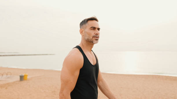istock Middle-aged muscular man walks along the promenade before jogging 1485810688