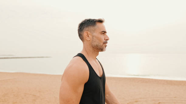 istock Middle-aged muscular man walks along the promenade before jogging 1485810689