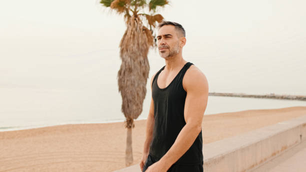 istock Middle-aged muscular man walks along the promenade before jogging 1485810691