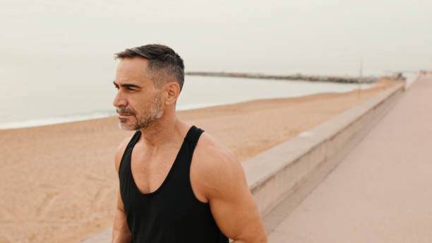 istock Middle-aged muscular man walks along the promenade before jogging 1485810724