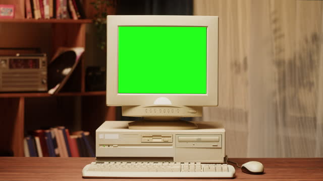Old computer with green chroma key screen close-up, Desktop PC. Retro room, obsolete technology.