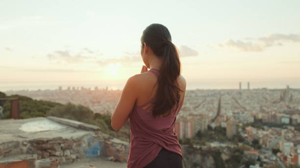 istock Girl meditates sitting on the observation deck at dawn, Back view 1485811156