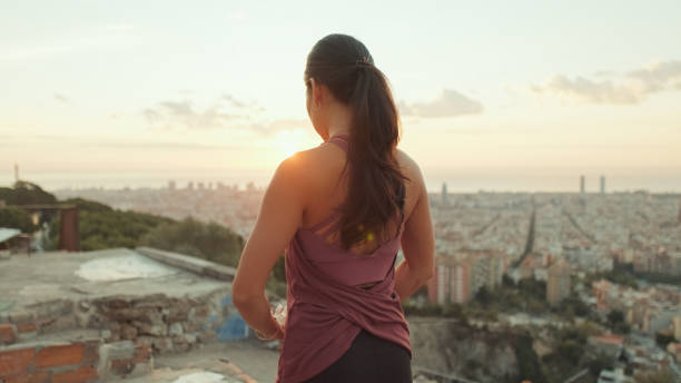 istock Girl meditates sitting on the observation deck at dawn, Back view 1485811159