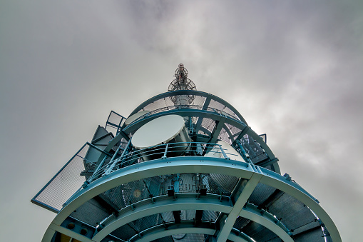 High angle view of Telecommunication tower with the background of thick clouds and copy space, on the top of mount Rigi, Switzerland.