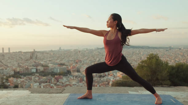 istock Young woman practices yoga at sunrise on viewing platform 1485811186