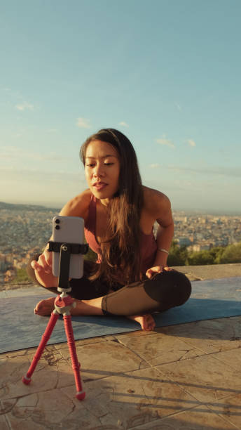istock Young woman giving yoga master class using mobile phone 1485811195