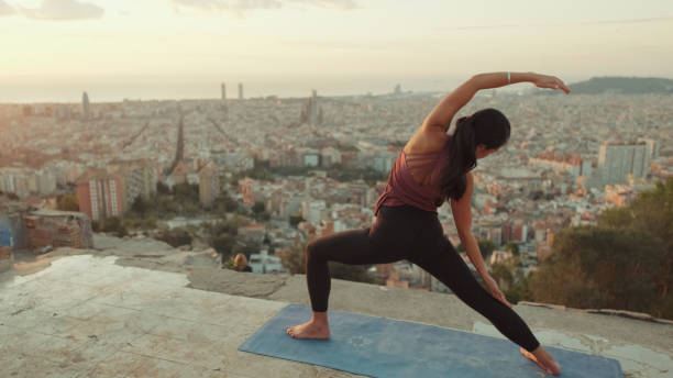 istock Young woman practices yoga at sunrise on viewing platform 1485811250