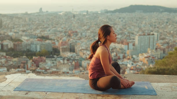 istock Young woman meditating while sitting in lotus position on the observation deck 1485812069