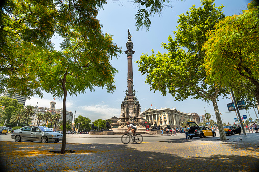 Barcelona, Spain - June 17, 2022:  monument column tribute to explorer Christopher Columbus on the wide tourist avenue promenade of La Rambla in Barcelona Catalonia Spain.  The statue is in honour of Columbus's first voyage to the Americas.