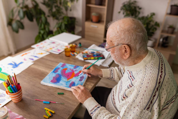 istock Male artist paints on a canvas in his studio 1485812977