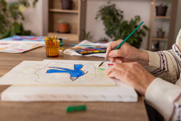 istock Senior man with dementia drawing in paper 1485813415