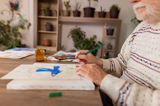 istock Senior man with dementia drawing in paper 1485813469