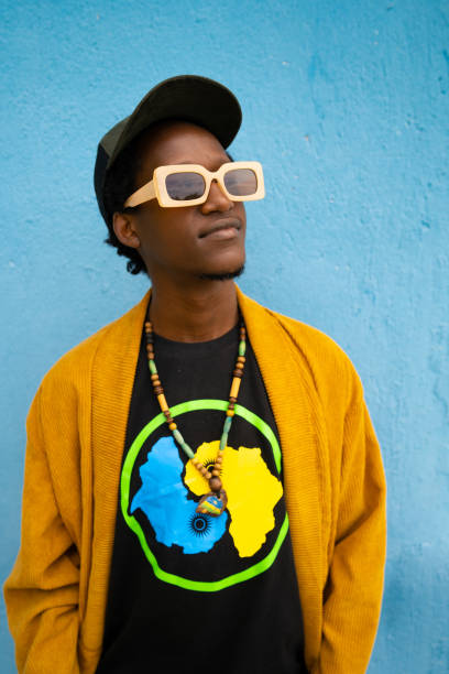 istock Happy young african man smiling against blue wall 1485815204