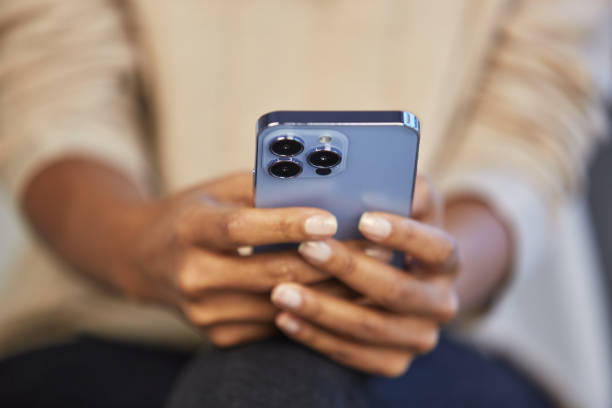 istock Young black woman typing text message on a smart phone. Unrecognizable BIPOC female texting online with a blue mobile phone 1485815459