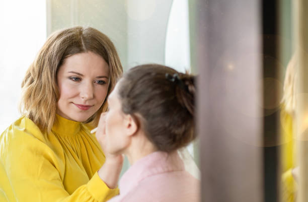 istock Makeup artist applying eyeshadow on a girl, Make up in process 1485816308