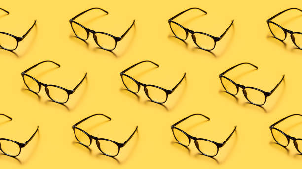 istock Modern black framed reading glasses or spectacles repeated on a bright yellow background with minimalist style. 1485818949