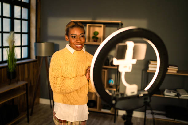 istock A woman is looking at her cellphone screen suspended in a selfie ring light 1485819358