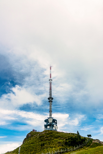 Telecommunication tower with the background of thick clouds and copy space, on the top of mount Rigi, Switzerland.