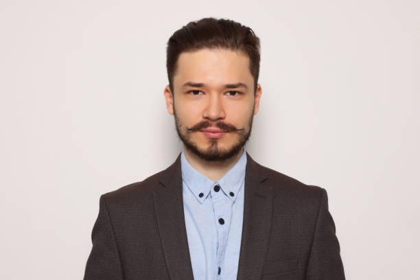 istock Handsome man in suit on light grey background 1485823881