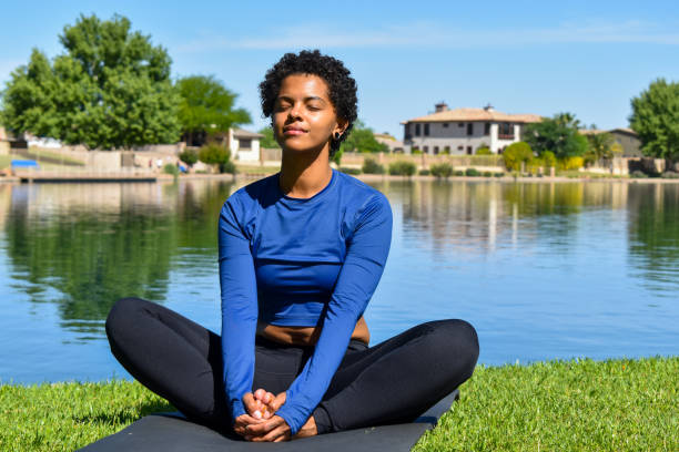istock Black Woman Doing Yoga On A Lakeshore 1485829432