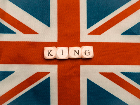 The inscription king on british union jack flag close up,coronation concept 6th May 2023.