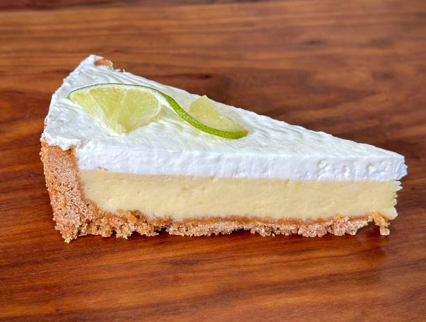 istock Slice of Key Lime Pie with Whipped cream on cutting board 1485832644