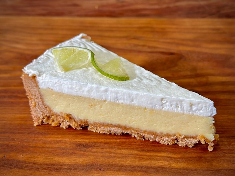 Slice of Key Lime Pie with Whipped Cream and Lime on top