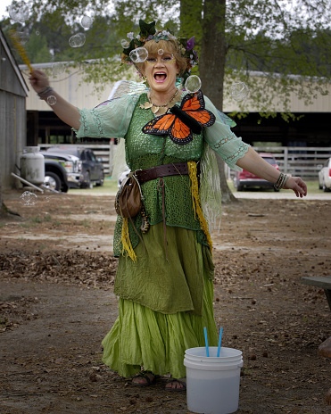 Courtland, Va- USA - April 2023: An actress dressed as a green fairy performing at a renaissance Festival in the Enchanted Forest