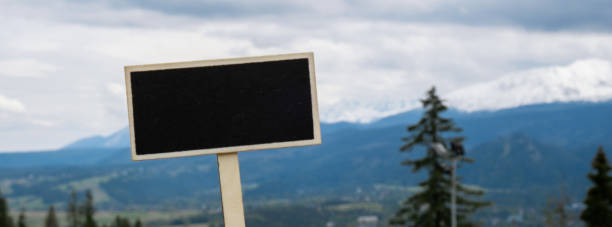 Empty blackboard label with copy space on background of Snowy mountains, green forests In National park Zakopane Poland. Mountain nature landscape. Travel outdoors green tourism concept Naturecore. Hiking wellbeing