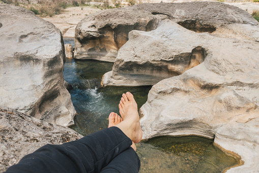 POV shot of feet relaxing at Pedernales Falls State Park