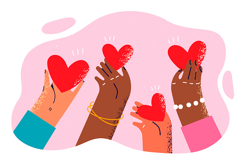 Hearts in hands of people of different races and nationalities symbolize kindness and charity towards ethnic minorities. Hands exchange valentines in form of hearts giving gifts on February 14