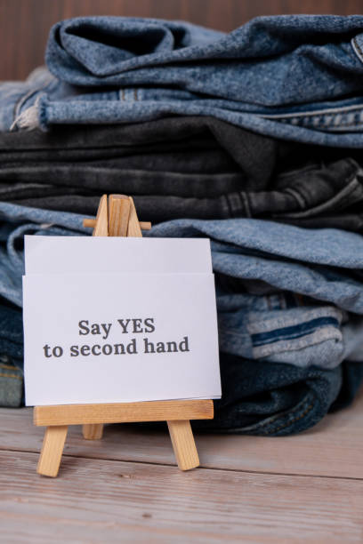 istock SAY YES TO SECOND HAND text on paper note on Jeans clothes assortment Second hand sustainable shopping. Capsule minimal wardrobe. Sustainable fashion overconsumption, conscious buying consumption, slow fashion 1485841652