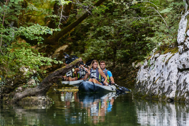 istock A group of friends enjoying having fun and kayaking while exploring the calm river, surrounding forest and large natural river canyons 1485846737