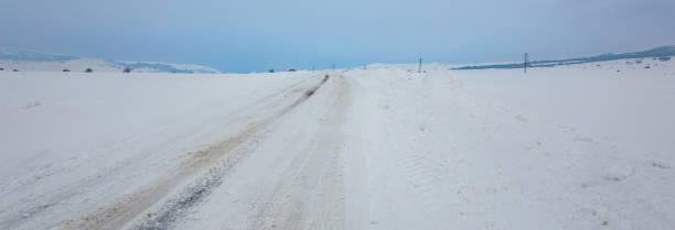istock snowy road and landscape 1485850919