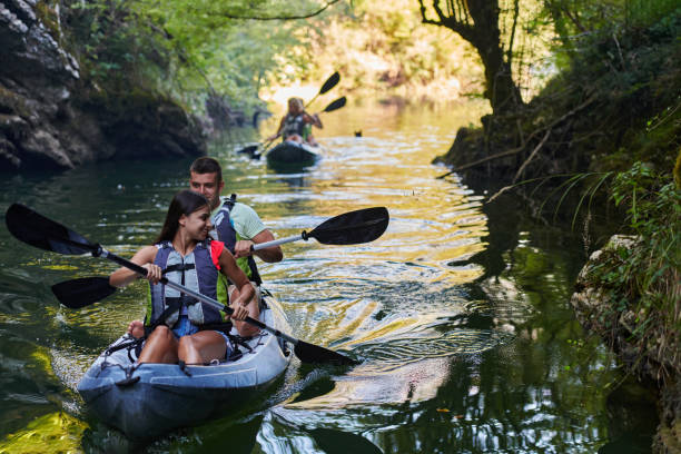 istock A group of friends enjoying having fun and kayaking while exploring the calm river, surrounding forest and large natural river canyons 1485851647