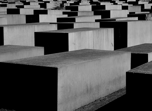 black and white close up of some concrete slabs, or stelae, a portion of the memorial to the murdered Jews of Europe, in central Berlin, near the Tiergarten and the Brandenburg Gate