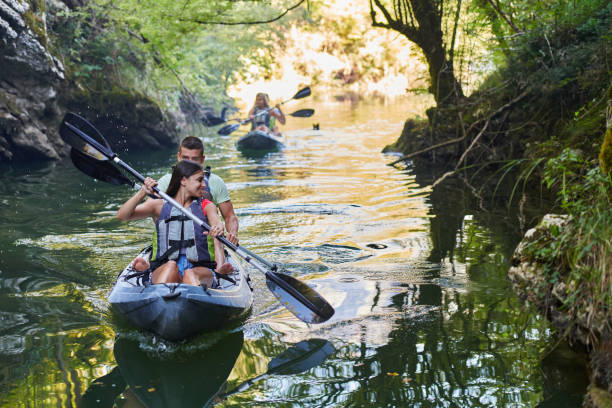 istock A group of friends enjoying having fun and kayaking while exploring the calm river, surrounding forest and large natural river canyons 1485852812