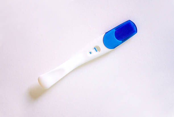 woman holding a pregnancy test kit