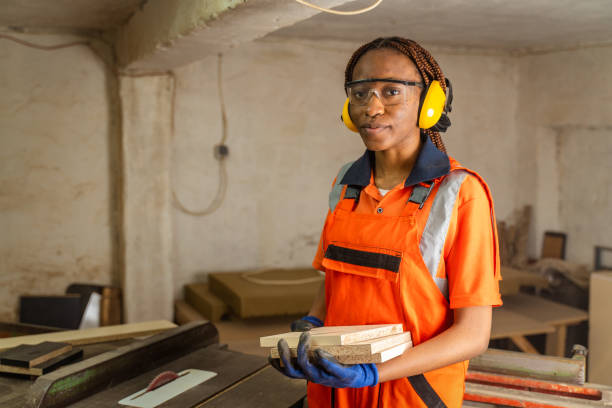 istock African-American female carpenter using circular 1485860182