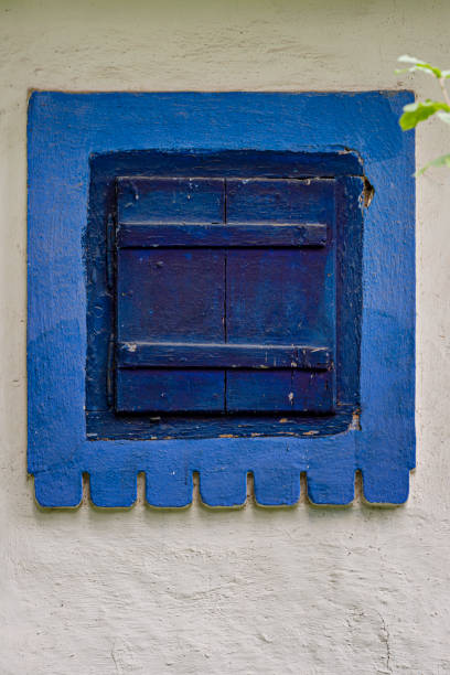 Blue wooden window with blue painted frame in vintage building