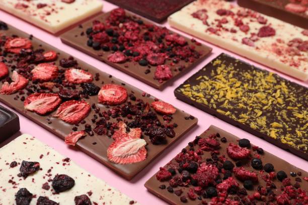 istock Different chocolate bars with freeze dried fruits on pink background 1485861685