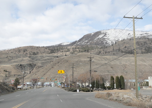 Cache Creek, Canada - April 2, 2023: Heading west on the Trans-Canada Highway to the village of Cache Creek. Spring morning with snow patches on the local hills in the Thompson-Nicola Regional District.