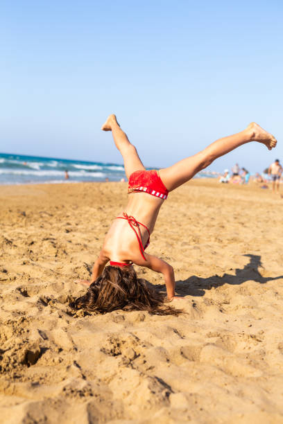 istock Girl playing on the beach 1485864212