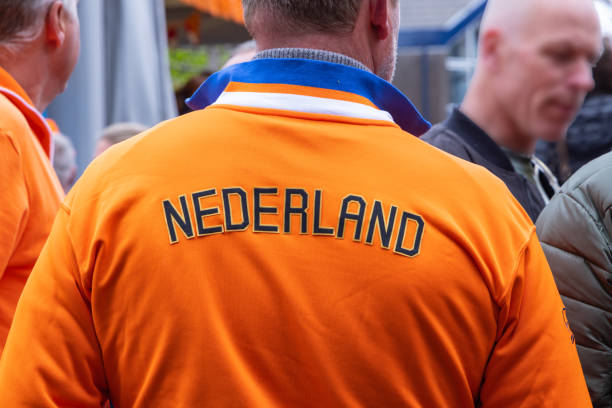 Europe, Netherlands, Utrecht, Maarssen. April 27, 2022. Man wearing an orange Netherlands team jacket.