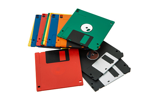 Multi-colored 3.5 floppy disks. Obsolete magnetic storage medium. Isolate on a white background.
