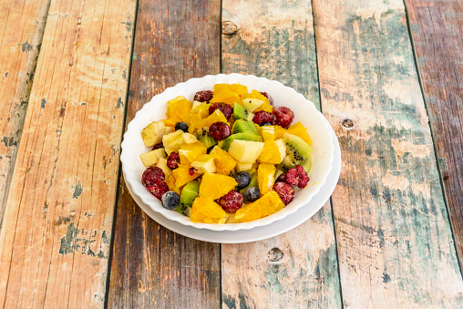 Fruit salad is a mixture of various fruits cut into small pieces, seasoned with sugar, syrup, liquor or fruit juice, very typical in some countries where it is eaten as a dessert