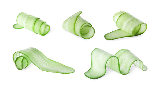 Set with slices of cucumbers on white background