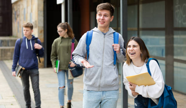 istock Two students discussing homework on street 1485868747
