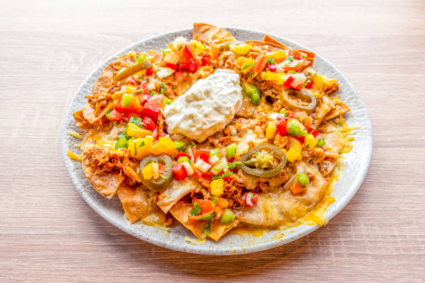 istock Corn nachos with cream cheese, pulled pork, sliced jelly beans, tricolor peppers and gratin cheddar cheese 1485869446