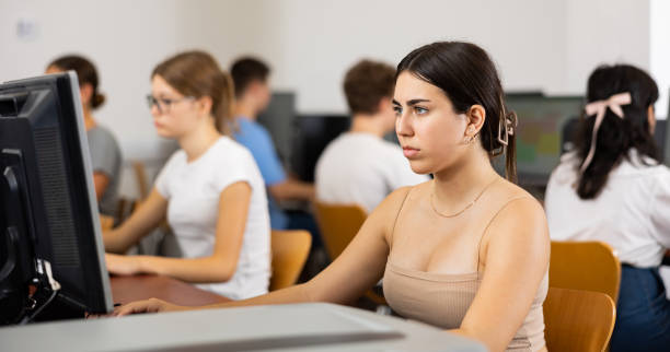 istock Focused Latin female teenager solving tasks of computer science in the auditory 1485869662